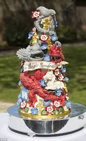 there is a decorative tower on top of the cake plate that has flowers and birds all over it