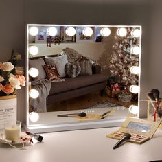 a living room scene with focus on the couch and lighted mirror in front of it