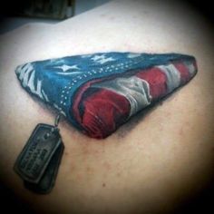 the back of a woman's shoulder with an american flag tattoo design on it