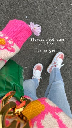 the feet of a person wearing pink and green knitted socks with flowers on them