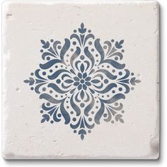 a white and blue tile with an intricate design