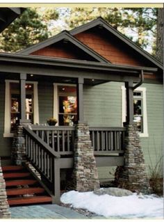 a small house with stone steps leading up to the front door