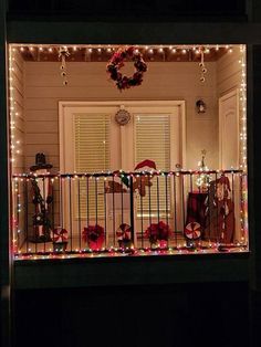 a house with christmas lights and decorations on the balcony