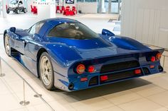 a blue sports car is on display in a showroom