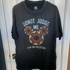 a black shirt with donuts on it that says donut judge me i'm on vacation