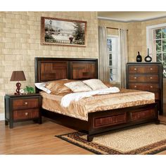 a bedroom with a bed and dressers in it