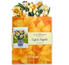 an orange bag with flowers in it and a postcard attached to the front that says fresh cut paper