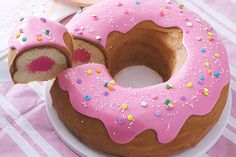 a pink frosted donut with sprinkles on it