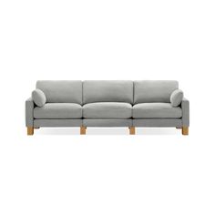 a grey couch with wooden legs on a white background