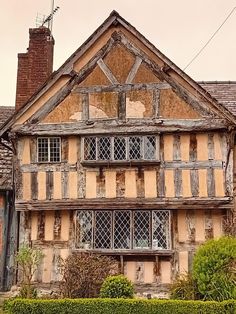 an old, run down house with lots of windows and shutters on the front