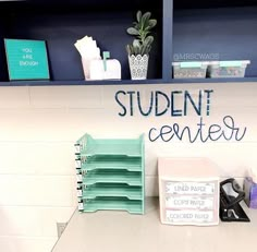 a desk with some books on it and a sign that says student center next to it