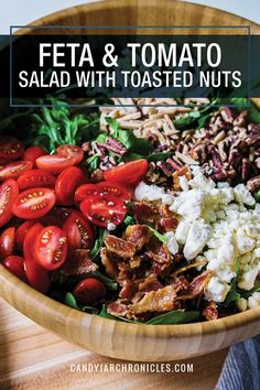 a wooden bowl filled with salad and tomatoes