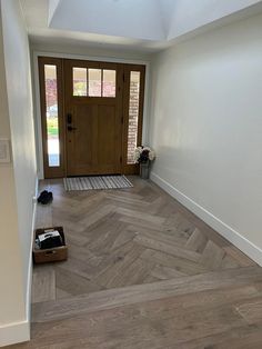 an empty room with a dog crate on the floor and a door in the background