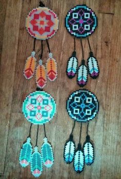 several beaded items are hanging on a wooden floor with beads in the shape of flowers