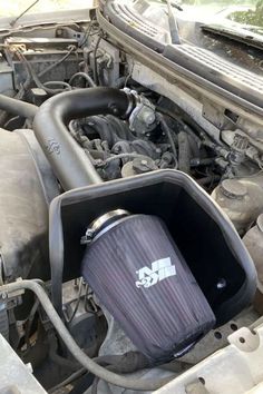 the engine compartment of a car with an air filter on it's hood,