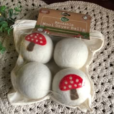 four white balls with red mushrooms on them