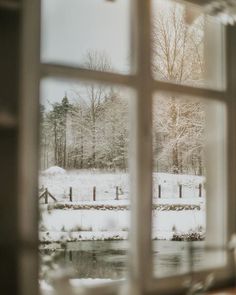 an open window looking out onto a snowy field