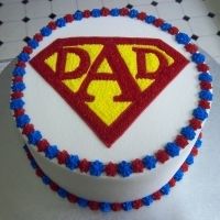 a cake decorated with the words dad and a superman symbol