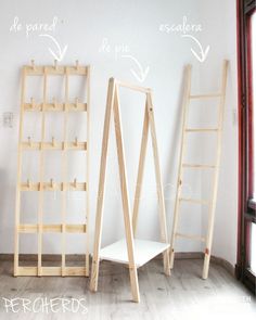 three wooden ladders sitting next to each other in front of a wall with writing on it