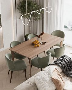 a dining room table with chairs and fruit on the plate next to it, in front of a large window