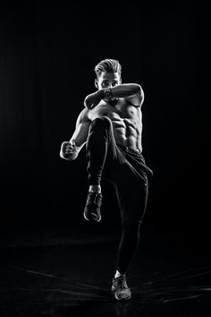 black and white photograph of a man doing kickbox