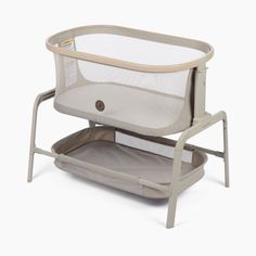 a baby crib with a white back and beige sides, on a white background