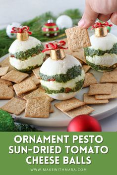 an ornament pesto sun - dried tomato cheese balls on a platter with crackers