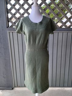 Lovely 1940s sage green wool knit dress by Lady Petite Fashion. Features decorative ruching/swirls along the neck and sleeves, and ribbing knit on the waist and skirt. This piece originally had a little matching sweater and belt, but neither is present. A classy figure-hugging knit dress, great for Fall. Worn once, washed, and stored in a drawer. In very good condition. I just noticed a couple of small stains one white and the other brown on the skirt (last two photos).  Bust - 36" un-stretched to 48" stretched (91.44 to 121.92 cm) Waist - 28" to 38" (71.12 to 96.52 cm)  Hips - 32" to 42" (81.28 to 106.68 cm) Measured 16 inches below armpit Length - 39" (99.06 cm)  Measured shoulder to hem Sleeves - 4" (10.16 cm) This dress is displayed on a size Small dress form. The form's bust is 34 inc Fitted Green Knit Sweater Dress, Wool Knitted Dress, Matching Sweaters, Fashion Media, Dress Sweater, Wool Knit, Green Wool, Small Dress, Dress Form