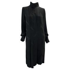 Presenting a gorgeous black silk pleated Yves Saint Laurent Rive Gauche monogram dress. From the Fall/Winter 1999 collection by Alber Elbaz, this long-sleeve dress features a hidden button-up front, mock neck, flowing sleeves, and pleating at the body. This dress is covered in the brand's 'YSL' monogram. A rare find, this vintage dress remains effortlessly chic and timeless. Approximate measurements: Size - FR38 Bust: 38" Waist: 34" Hips: 49" Shoulder to hem: 42" Shoulder to cuff: 26" Underarm t Ossie Clark, Alber Elbaz, Slim Aarons, Vintage Monogram, Rive Gauche, Monogram Prints, John Galliano, Black Silk, Pleated Dress