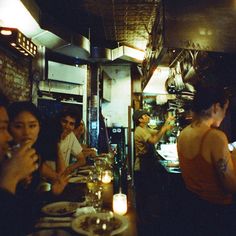 a group of people sitting at a table in a restaurant