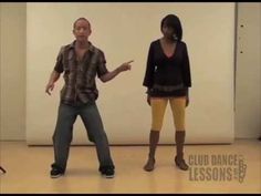 a man and woman are dancing in a dance studio with one pointing at the other