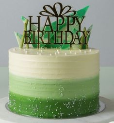 a birthday cake with green and white frosting