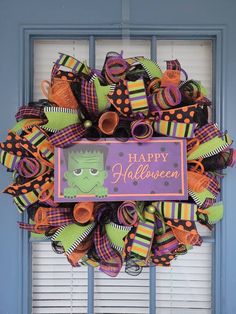 a halloween wreath with the words happy halloween on it