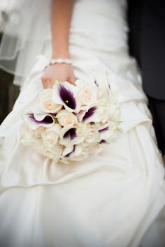 a bride holding a bouquet of flowers in her hand