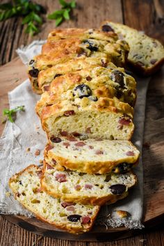 sliced loafs of bread with olives and cheese