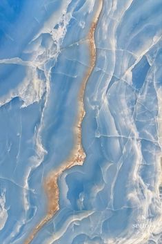 an aerial view of the earth's surface with blue and white paint on it