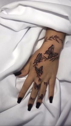 a woman's hand with butterflies on it