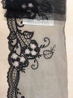 black lace with flowers and leaves on it