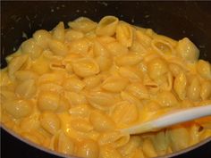 macaroni and cheese being cooked in a pan