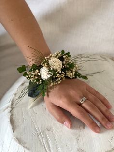 a close up of a person's hand with a ring on top of a cake