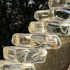 several glass bottles are stacked on top of each other