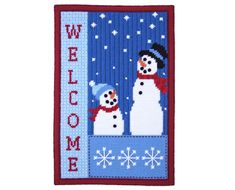 a cross stitch snowman welcome sign with two snowmen in the background, on a blue and red border