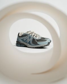 a pair of new balance running shoes sitting on top of a white surface with circles around them