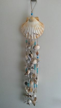 a sea shell wind chime hanging on the wall