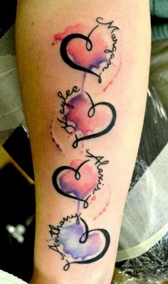 a woman's leg with two hearts and the word love tattooed on her arm