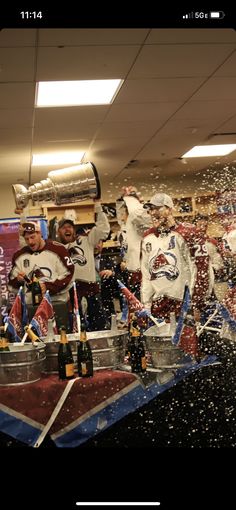 the hockey team is celebrating with champagne and confetti