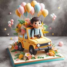 a yellow car with balloons and flowers on the roof is parked in front of a gray background