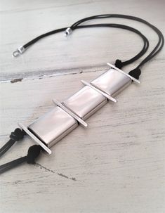 "Womens long leather necklace, silver square tubes necklace, statement necklace, uno de 50 contemporary necklace, edgy style necklace Welcome to my shop! ✈️ DHL EXPRESS SHIPPING AVAILABLE, 1-3 BUSINESS DAYS DELIVERY! ✔️ PLEASE MAKE SURE TO SELECT IT, RIGHT BEFORE YOUR PURCHASE! ❗️ ❗️ DON'T FORGET TO ADD YOUR CELL # AT THE \"NOTE TO SELLER\" SECTION IF YOU CHOOSE DHL! BY FILLING YOUR CELL NUMBER YOU EARN THE BENEFIT TO CHOOSE BETWEEN 6 DIFFERENT DELIVERY OPTIONS! INSTRUCTIONS WILL BE SENT TO YOUR Modern Silver Necklace With Adjustable Cord, Modern Adjustable Rectangular Necklace, Long Leather Necklace, Tube Necklace, Contemporary Necklace, Edgy Style, Necklace Statement, Lariat Necklace, Matching Bracelets