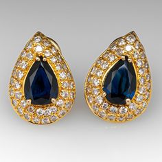 These gorgeous sapphire earrings are each centered with a pear cut sapphire in a four-prong setting. The center is accented by forty (40) bead set, round brilliant cut diamonds. The earrings measure 18.9mm long by 13.6mm wide and 6.2mm deep, finished with omega style clip on backs. We can add a post for pierced ears if you prefer. Elegant Blue Pear-shaped Diamond Earrings, Blue Teardrop Diamond Earrings For Anniversary, Elegant Sapphire Diamond Earrings, Formal Sapphire Diamond Earrings With Diamond Accents, Elegant Sapphire Diamond Earrings For Formal Occasions, Formal Blue Pear-shaped Diamond Earrings, Blue Pear-shaped Diamond Earrings For Anniversary, Formal Diamond Earrings With Gemstone Accents, Classic Teardrop Jewelry With Gemstone Accents