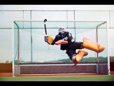 a man is diving in the air to catch a ball with a baseball bat and glove